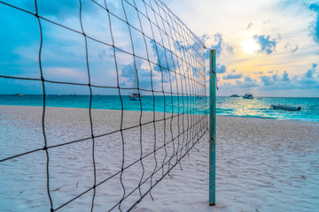 Volleyball net on a deserted sandy beach on the tropical sea.