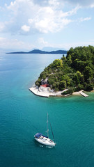 Obraz premium Aerial drone bird's eye view photo of iconic port of Nidri or Nydri a safe harbor for sail boats and famous for trips to Meganisi, Skorpios and other Ionian islands, Leflkada island, Ionian, Greece