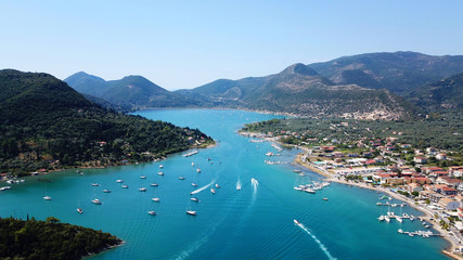 Aerial drone bird's eye view photo of iconic port of Nidri or Nydri a safe harbor for sail boats and famous for trips to Meganisi, Skorpios and other Ionian islands, Leflkada island, Ionian, Greece