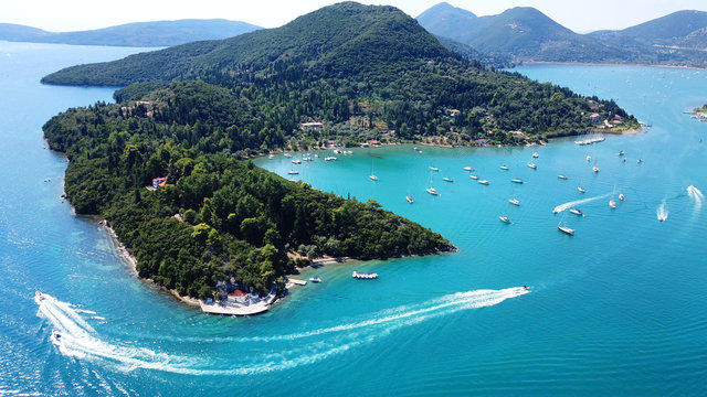 Aerial drone bird's eye view photo of iconic port of Nidri or Nydri a safe harbor for sail boats and famous for trips to Meganisi, Skorpios and other Ionian islands, Leflkada island, Ionian, Greece