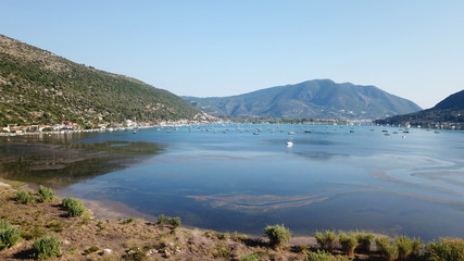 Aerial drone bird's eye view photo of iconic port of Nidri or Nydri a safe harbor for sail boats and famous for trips to Meganisi, Skorpios and other Ionian islands, Leflkada island, Ionian, Greece
