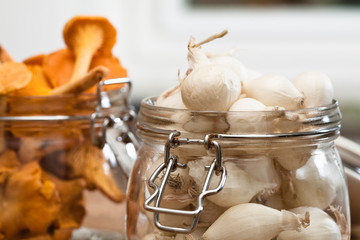 Fototapeta na wymiar Stockholm, Sweden - Closeup cropped image of pearl onions and dried mushrooms in jars.