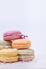 Few colored macarons on a white background