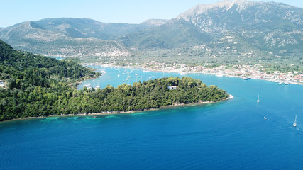 Fototapeta premium Aerial drone bird's eye view photo of iconic port of Nidry or Nydri a safe harbor for sail boats and famous for trips to Meganisi, Skorpios and other Ionian islands, Leflkada island, Ionian, Greece