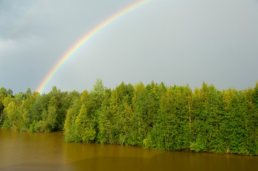 Russia, Typical river views between Goritzy & Kizhi Island. White Lake area, rainbow over the forest.