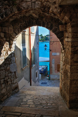 Fototapeta na wymiar Arched walkway framing view of Adriatic Sea, Rovigno, Croatia
