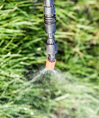 Spraying herbicide from the nozzle of the sprayer manual