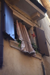 Fototapeta na wymiar open window with curtain in Italy