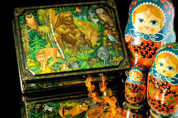 Russia, Russian handicrafts. High quality painted lacquer box showing the wildlife of Russia, amber & matryoshka dolls.