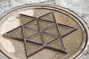 Spain, Castilla-La Mancha,Toledo. Manhole cover in Jewish district.