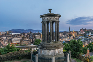 Great Britain, Scotland, Edinburgh. Sunset Looking Down on the Stewart Monument and the City from Calton Hill
