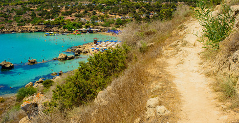  blue sea with clear water, mountains, yachts and the beach on the panorama of Konnos Bay Cyprus
