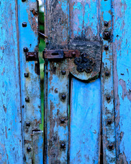 England, Dartington. An ancient hasp adorns this old blue gate in the Dartmoor area of Devon, England.