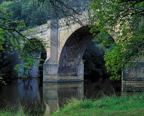 England, Durham. The graceful arches of this stone bridge span the still waters of River Wear, Durham, England.