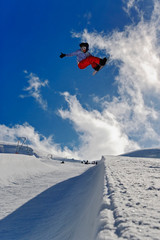 Naklejka na ściany i meble Snowboarder jumping in halfpipe, Klein Matterhorn, Zermatt, Switzerland.