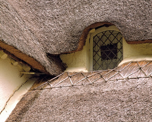 England, Selworthy. A close-up pictures shows the finishing touches on a thatched-roof in Selworthy, a National Trust Village, in Somerset, England.