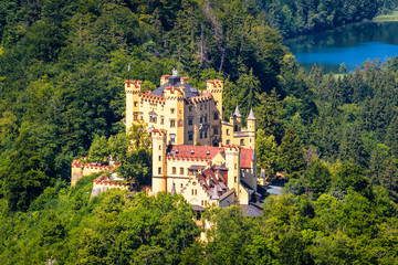  Aerial scenic view of Hohenschwangau Castle, Germany. Landscape with castle and lake in Alps. - obrazy, fototapety, plakaty