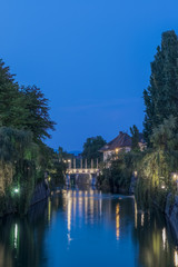 Fototapeta na wymiar Slovenia, Ljubljana, Ljubljana River and Cobbler's Bridge at Dawn