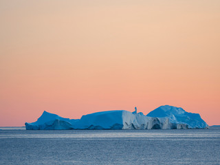 Fototapeta na wymiar Icebergs in the Disko Bay. Inuit village Oqaatsut (once called Rodebay) located in Greenland, Denmark