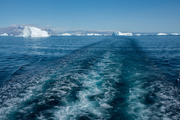 Greenland, Scoresbysund, aka Scoresby Sund, Nordvestfjord. Expedition ship wake as it sails through iceberg filled fjord. © Cindy Miller Hopkins/Danita Delimont