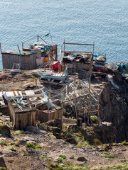 Fishing shed with nets, fishing gear and dog sled. Small town of Uummannaq, northwest Greenland.