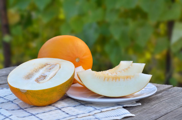 Yellow sweet melon on wooden table. Closeup, selective focus