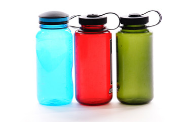 Blue, Red, And Green Bottles On White Background.