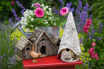 Fototapeta na wymiar Close-up of bird houses and planter on garden table. 
