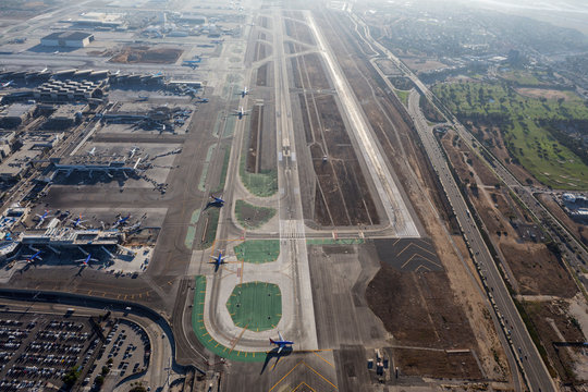Afternoon aerial view of airplanes lining up on the main runway at LAX airport on August 16, 2016 in Los Angeles, California, USA.