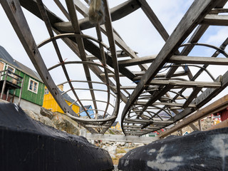 Kayak on rack belonging to the local kayak club. Small town of Uummannaq, northwest Greenland.