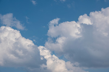 White clouds on the blue sky. Abstract background with clouds on blue sky. In the clear sky high floating clouds.