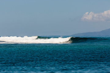 Fototapeta premium Pacific Ocean, French Polynesia, Society Islands, Huahine. Waves breaking on deep blue ocean.