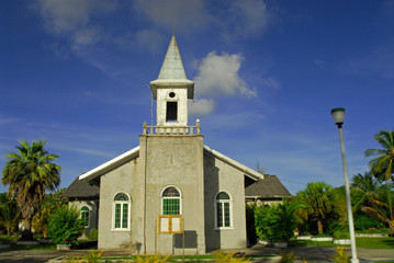 Small church surrounded by green trees