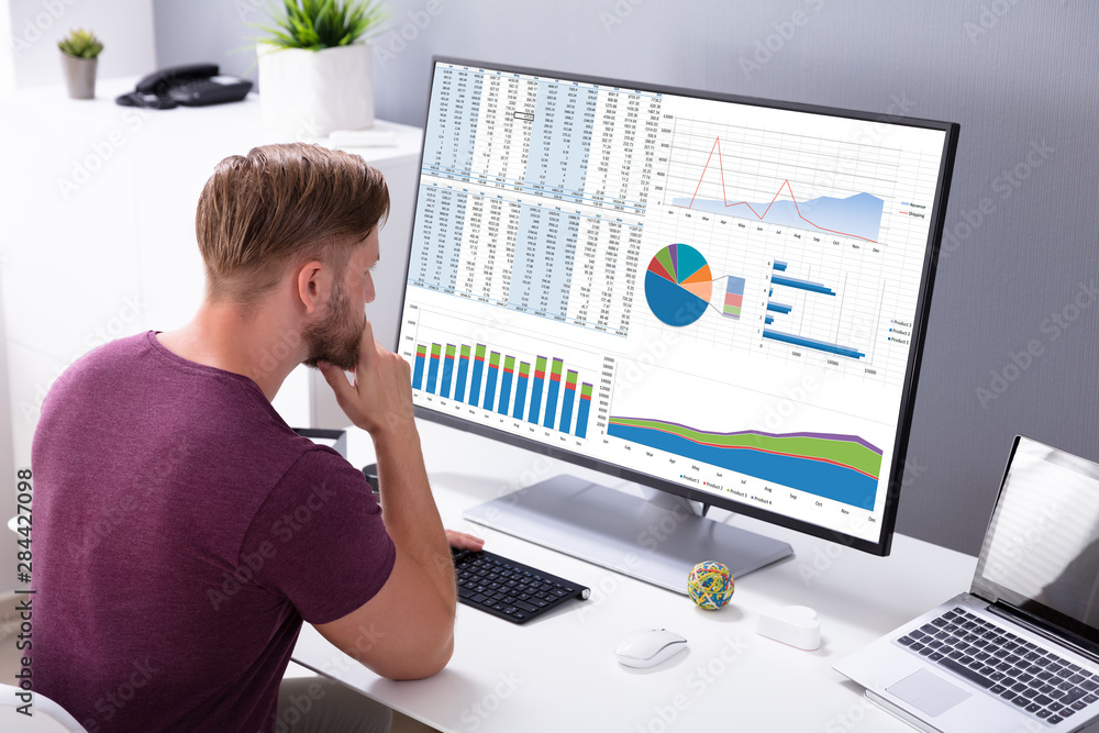Poster businessman analyzing graph on computer