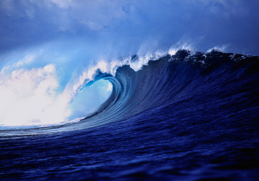 Fiji Islands, Tavarua, Cloudbreak. A stunning wave curl reveals impossible shades of blue, Tavarua, Fiji Islands.