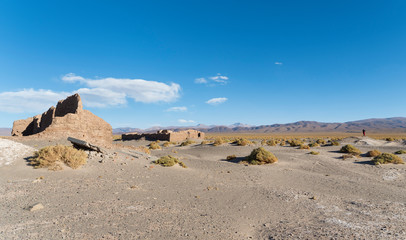 Fototapeta na wymiar Ruins of buildings for salt processing. Landscape at Salinas Grandes salt flats in the Altiplano, Argentina.