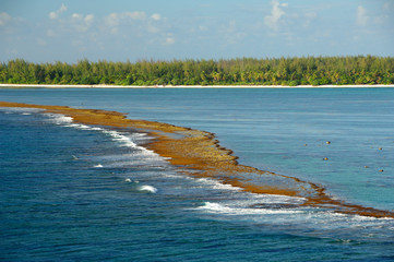 South Pacific, French Polynesia, Bora Bora. Teavanui Pass, the only access through coral reef that surrounds Bora Bora. View of tiny reef islands (aka motus) in distance.