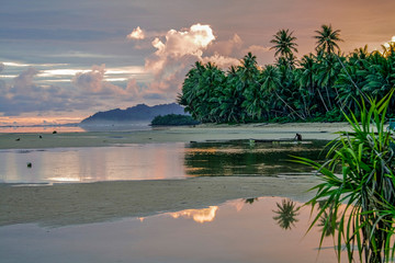 Walung, Kosrae, Micronesia. Local man prepares outrigger canoe at dawn for day of fishing.