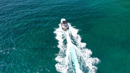 Aerial top view luxury inflatable rib speed boat cruising in Mediterranean emerald sea