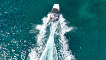 Obraz premium Aerial top view luxury inflatable rib speed boat cruising in Mediterranean emerald sea