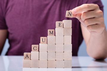 Person Placing Last Alphabet Of Word Acumen