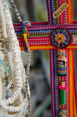 Belize, Placencia. Detail of colorful traditional textile souvenir cross.