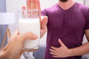 Man Rejecting Glass Of Milk