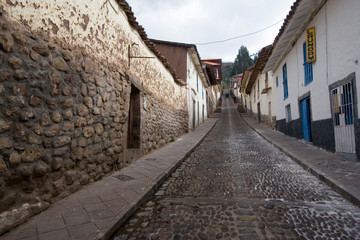Fototapeta na wymiar South America - Peru. Old and new building elements along cobblestone street in Cusco.