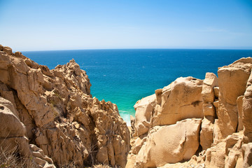 Fototapeta na wymiar Cabo San Lucas, Baja California Sur, Mexico - View of the ocean with a large rock formation in the foreground.