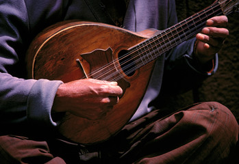 Peru, Cuzco. A street musician stums his guitar in the Plaza in Cuzco, Peru