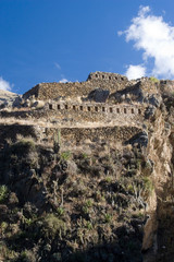 Fototapeta premium South America - Peru. Small portion of Inca fortress on hill overlooking village of Ollantaytambo in Sacred Valley of the Incas.