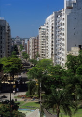 Fototapeta na wymiar Uruguay, Montevideo, sun-washed while buildings line a bisy residential street with a view to the national Capitol building.