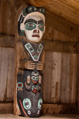 USA, Alaska, Kasaan. Close-up of human and other figures on totem pole in Indian longhouse. 