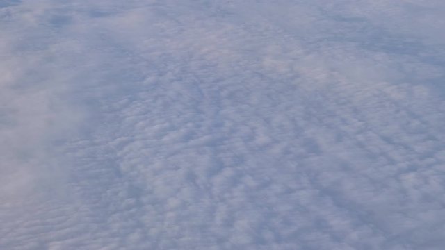 Aerial shot of flying above cirrocumulus clouds.